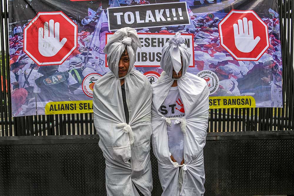 Massa dari Tenaga medis dan kesehatan melakukan aksi teatrikal di depan gedung MPR/DPR-DPD, Senayan, Jakarta, Senin (5/6/2023). Massa tersebut melakukan aksi damai untuk menolak pembahasan rancangan undang-undang atau RUU Kesehatan Omnibus Law. ANTARA FOTO/Galih Pradipta