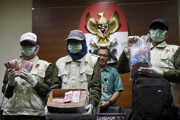 Ilustrasi: Petugas memerlihatkan barang bukti uang yang diamankan dari operasi tangkap tangan (OTT) di Bengkulu saat konferensi pers di gedung KPK, Jakarta, Rabu (21/6)./Antara-Hafidz Mubarak A