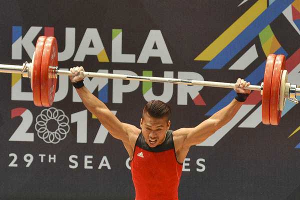 Lifter Indonesia Deni bertanding dalam angkat besi putra nomor 59 kg Sea Games XXIX Kuala Lumpur di MITEC, Kuala Lumpur, Malaysia, Selasa (29/8). Deni berhasil meraih medali emas dengan total angkatan 312 kg./Antara-Wahyu Putro