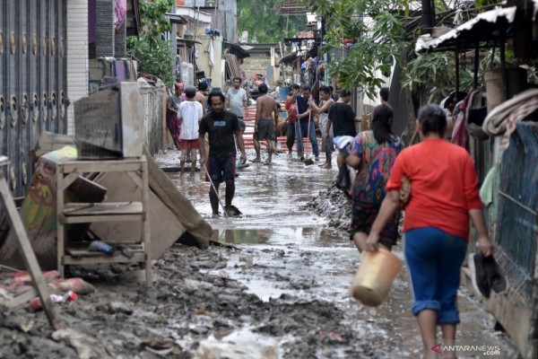 Sejumlah warga membersihkan lumpur pasca banjir yang menggenangi wilayah Jalan Mawar V RT. 008 RW 03, Kelurahan Margahayu, Bekasi Timur, Kota Bekasi, Jawa Barat, Senin (6/1/2020)./ANTARA FOTO-Suwandy