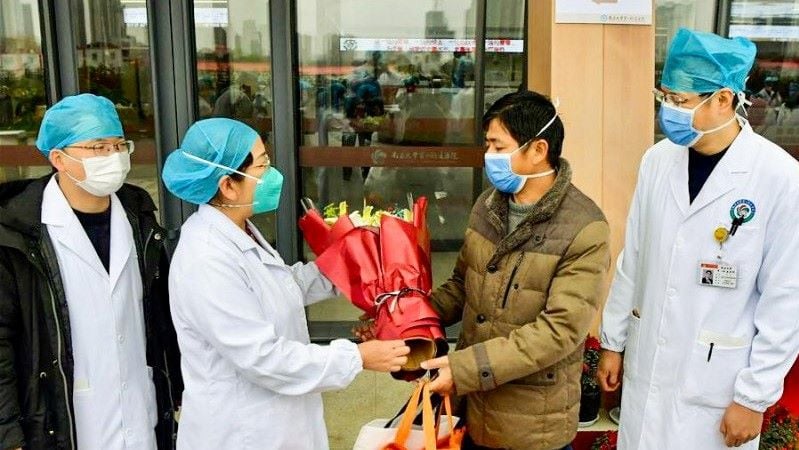 Seorang pasien (dua kanan) menerima karangan bunga dari staf medis Rumah Sakit Nanchang University, Nanchang, Provinsi Jiangxi, setelah dinyatakan sembuh dari infeksi 2019-nCoV pada 27 Januari 2020. (ANTARA/HO-ChinaNews/mii)