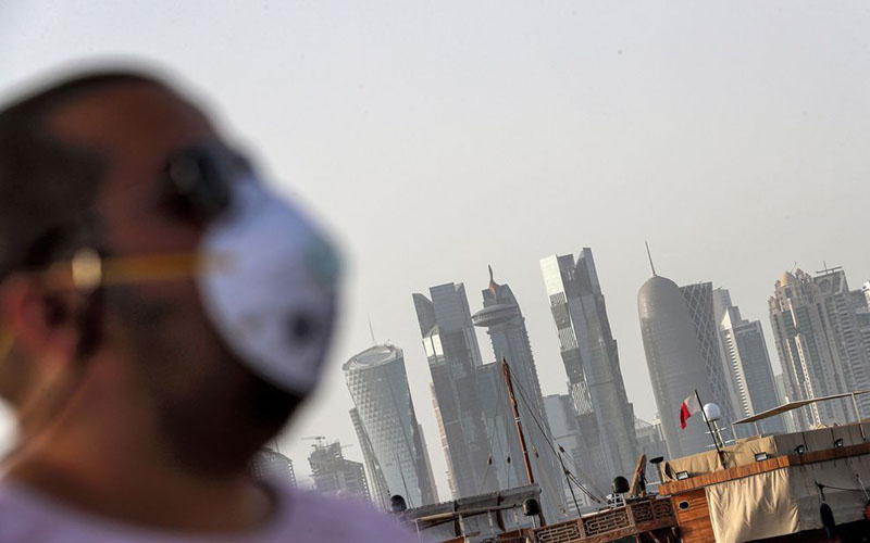 Seorang lelaki mengenakan masker di Doha, ibu kota Qatar./Bloomberg
