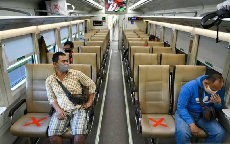 Sejumlah penumpang dengan mengenakan masker di dalam gerbong kereta api luar biasa relasi Gambir-Surabaya Pasar Turi lintas selatan di Stasiun Gambir, Jakarta./Antara