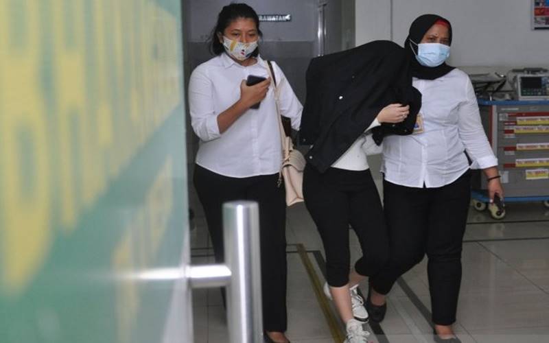 Personel kepolisian membawa artis berinisial H (tengah) saat menjalani pemeriksaan kesehatan di Rumah Sakit Bhayangkara Polda Sumut, Medan, Sumatra Utara, Senin (13/7/2020). H yang merupakan selebgram dan artis Film Televisi (FTV) tersebut ditangkap Polrestabes Medan dari sebuah hotel yang diduga terlibat dalam kasus prostitusi./ANTARA-Septianda Perdana