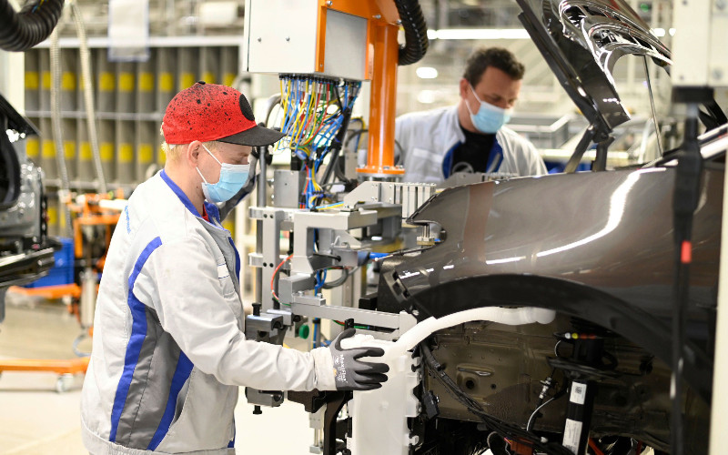 Dua karyawan Volkswagen di pabrik Zwickau memasang lampu depan pada ID.3. Pabrik ini beroperasi kembali sejak 27 April 2020 dengan menerapkan protokol kesehatan, seperti pemakaian penutup mulut-hidung di tempat kerja dengan jarak antarpekerja kurang dari 1,5 meter. 