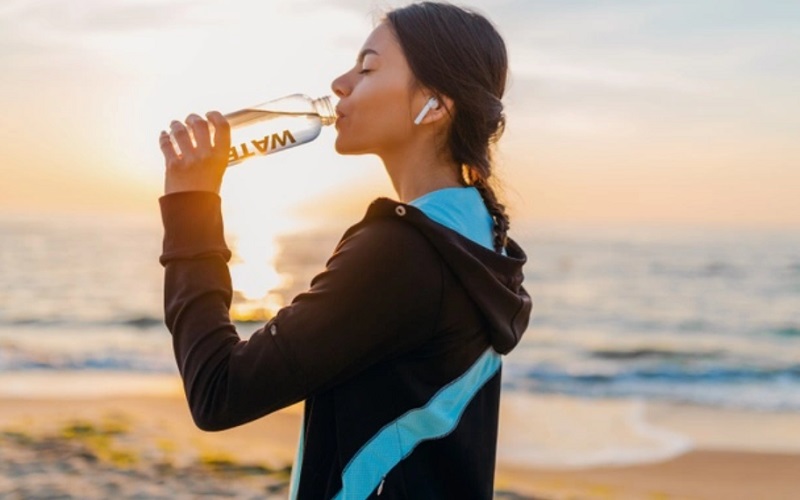 Ilustrasi perempuan meminum air putih untuk jaga imunitas tubuh - Freepik