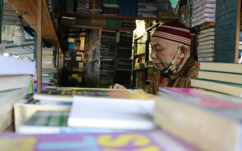 Marno, salah seorang pedagang buku di kawasan Stadion Diponegoro Kota Semarang, tengah menunggu pembeli pada Jumat (7/1/2022) siang./BISNIS-Muhammad Faisal Nur Ikhsan.