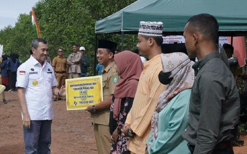 Gubernur Riau Syamsuar (kiri) menyalurkan Bantuan Keuangan Khusus (BKK) di Desa Buruk Bakul, Bengkalis Riau. /Istimewa