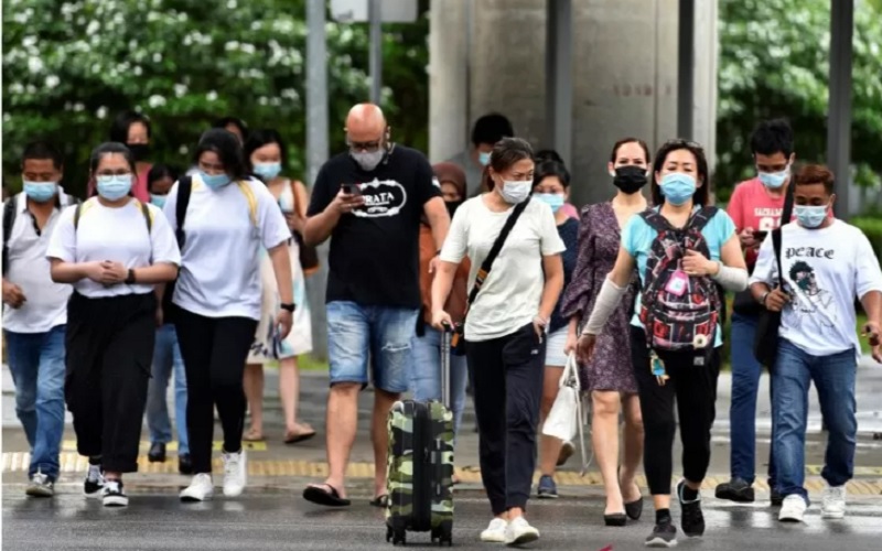 Warga menyeberang jalan di tengah penyebaran penyakit Covid-19 di Singapura, Jumat (14/5/2021)./Antara-Reuters