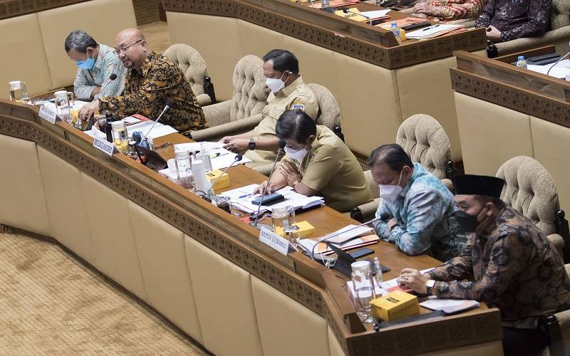 Ketua KPU Ilham Saputra (kedua kiri) menyampaikan paparan dengan didampingi Mendagri Tito Karnavian (ketiga kiri), dan Ketua Bawaslu Abhan (kedua kanan) serta jajaran tiga instansi tersebut dalam rapat kerja bersama Komisi II DPR di kompleks Parlemen, Jakarta, Senin (24/1/2022). Dalam rapat tersebut disepakati Pemilu 2024 akan digelar pada 14 Februari 2024./Antara