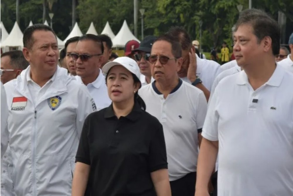 Ketua Dewan Pengurus Pusat (DPP) Bidang Politik dan Keamanan PDI Perjuangan Puan Maharani (tengah) bersama Ketua Umum Partai Golongan Karya AIrlangga Hartarto (kanan) dan Wakil Ketua Umum Golkar Bambang Soesatyo (kiri) berbincang saat jalan santai di Monas, Jakarta, Sabtu (8/10/2022)./Antara