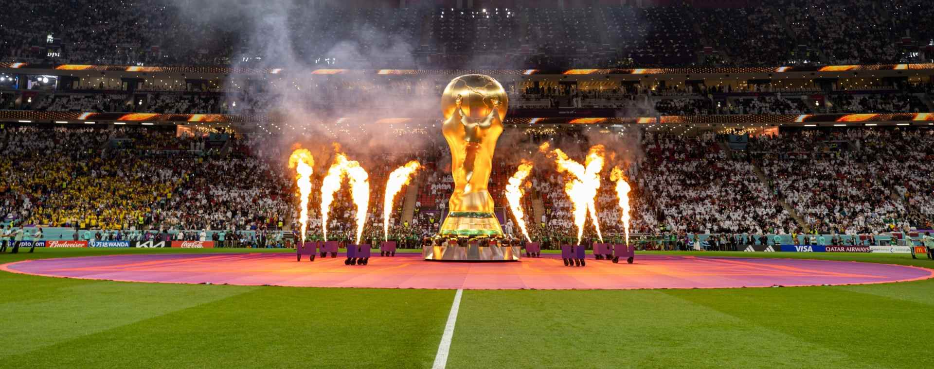 Kembang api mengelilingi patung Piala Dunia menjelang pertandingan pembukaan Piala Dunia 2022 antara tuan rumah Qatar dan Ekuador, di Stadion Al Bayt di Al Khor, Qatar, pada hari Minggu, 20 November 2022.  - Bloomberg. Bursa Taruhan Juara Piala Dunia 2022 dari Kacamata Ekonom Global