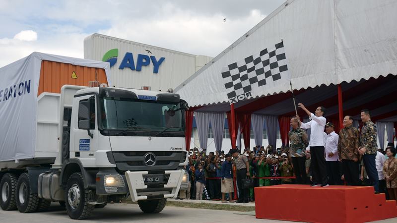 Presiden Joko Widodo mengibarkan bendera saat melepas keberangkatan truk kontainer berisi serat rayon untuk diekspor ke Turki sebanyak 10.190 ton, di pabrik Asia Pacific Rayon (APR), Kabupaten Pelalawan, Riau, Jumat (21/2/2020)./ ANTARA - FB Anggoro.