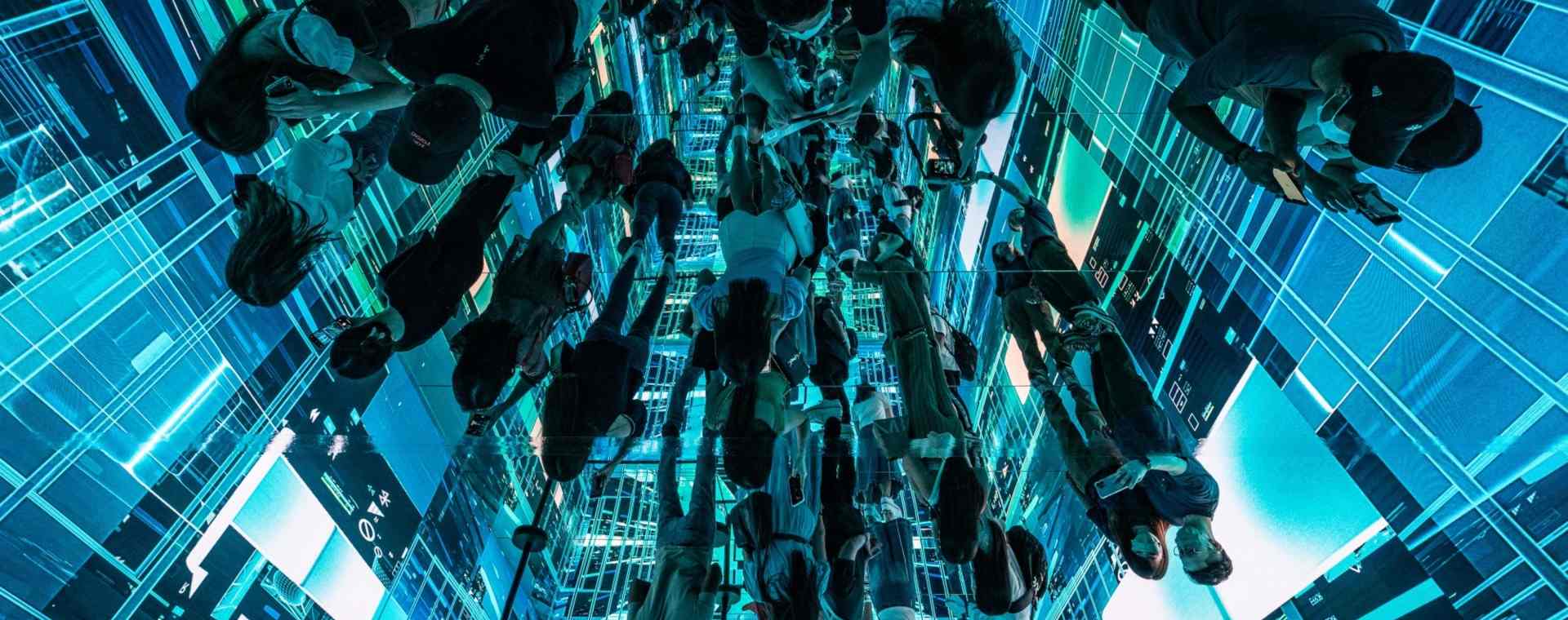 Refleksi pengunjung yang melihat instalasi seni imersif berjudul Machine Hallucinations – Space: Metaverse oleh Refik Anadol di Digital Art Fair Asia yang menampilkan seni digital dan NFT di Hong Kong./Bloomberg-Lam Yik