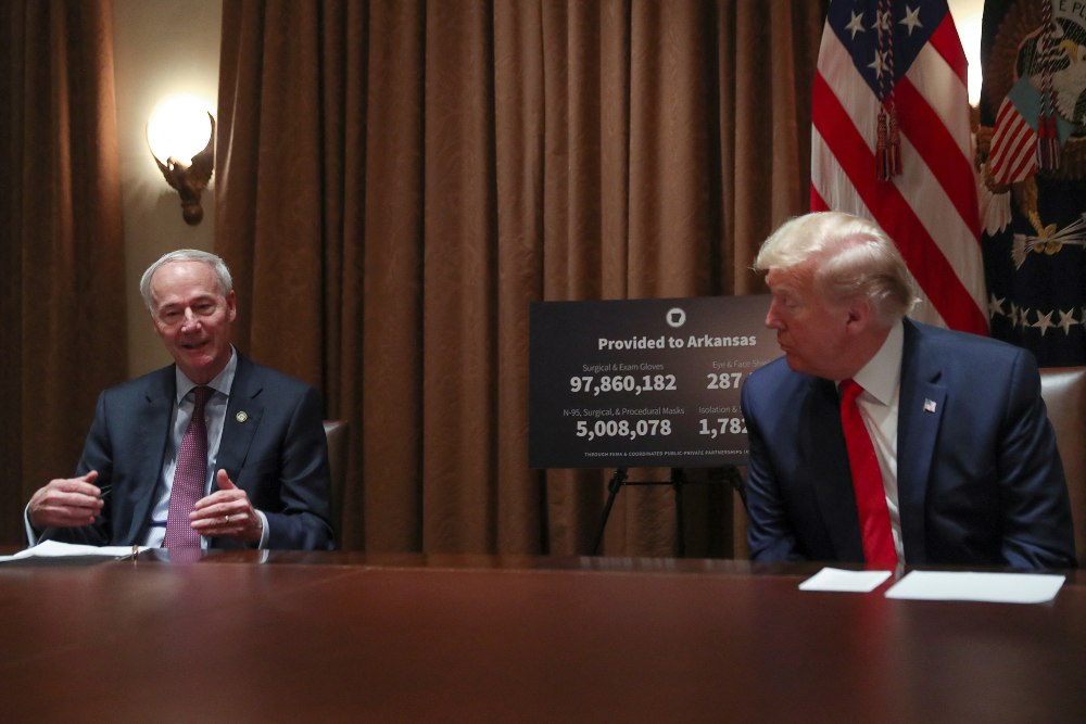 Presiden Amerika Serikat (AS) Donald Trump mendengarkan Gubernur Arkansas Asa Hutchinson berbicara tentang respons pandemi Covid-19 selama pertemuan dengan Hutchison dan Gubernur Kansas Laura Kelly di Ruang Kabinet di Gedung Putih di Washington, AS, 20 Mei 2020. REUTERS/Leah Millis/File Foto