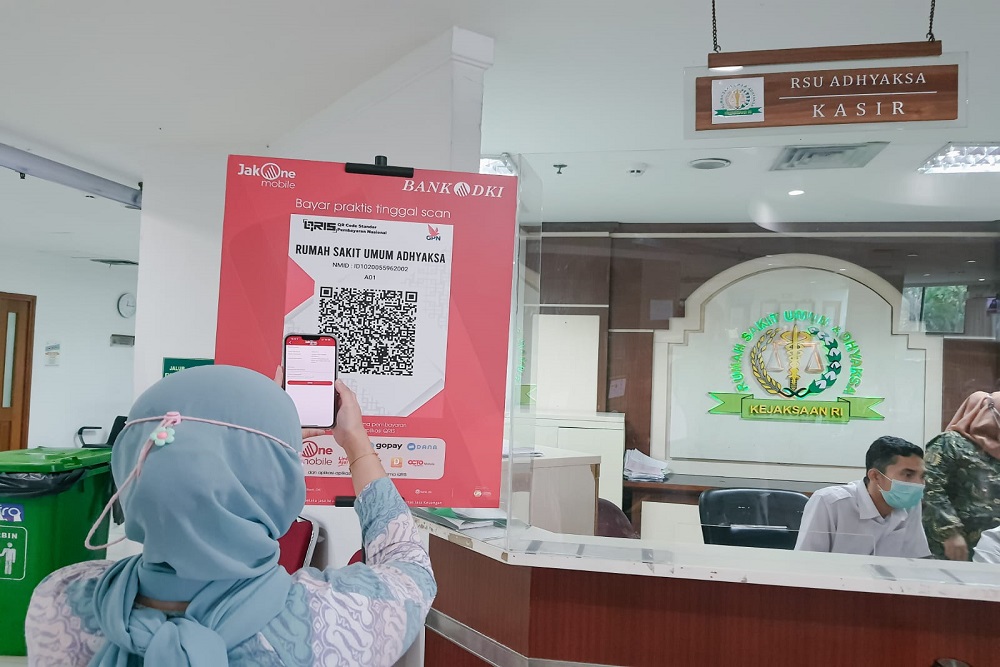 Warga melakukan pembayaran secara non tunai melalui QRIS Bank DKI di RSU Adyaksa, Jakarta Timur/Bank DKI