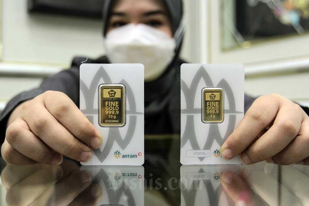 Karyawan menunjukkan emas di Galeri 24 Pegadaian, Jakarta, Senin (16/1/2023). Bisnis/Fanny Kusumawardhani. Lebaran, Saatnya Intip Harga Emas Pegadaian yang Turun Rp3.000
