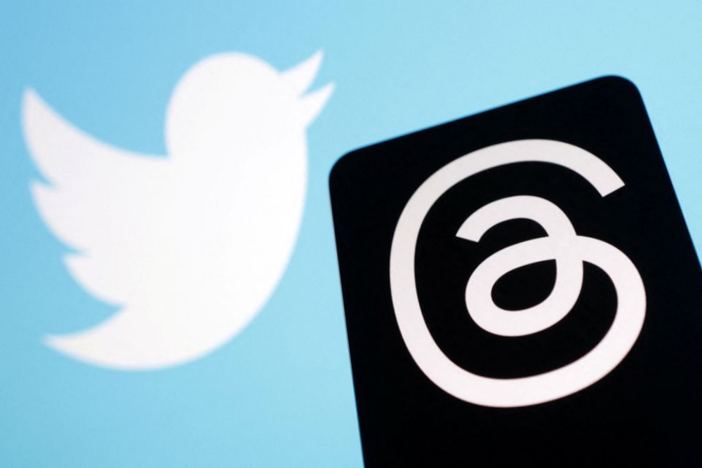 Ilustrasi aplikasi Threads dan logo Twitter/Reuters