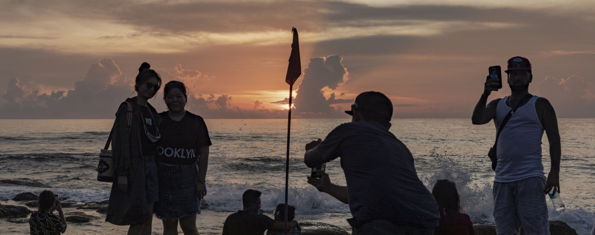 Wisatawan berfoto di Tanah Lot, Bali pada Desember 2022. Kunjungan wisatawan mancanegara ke Indonesia sempat anjlok saat krisis 1998 dan saat pandemi Covid-19. - Bloomberg/Nyimas Laula