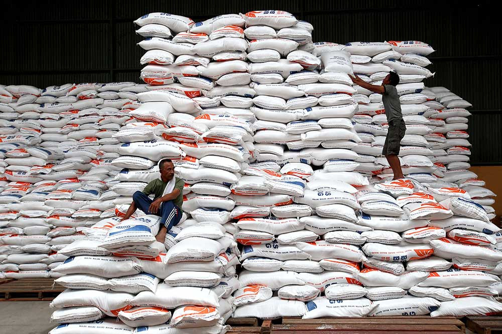 Buruh melakukan bongkar muat karung berisi beras di Gudang Bulog Divre Jawa Barat di Gedebage, Bandung, Jawa Barat, Senin (30/1/2023). Bisnis/Rachman