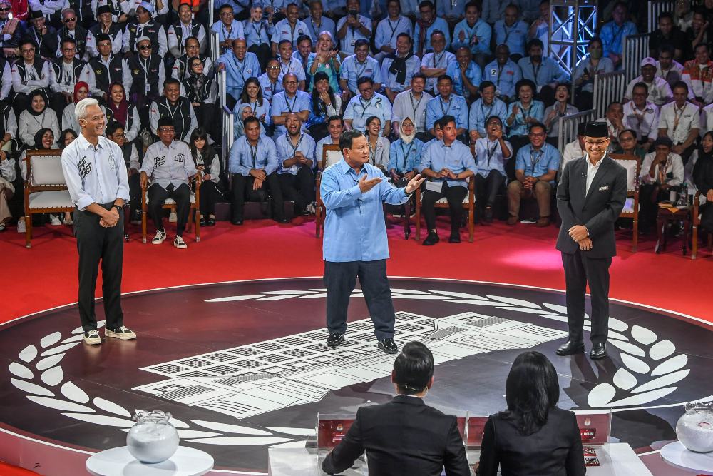 Capres nomor urut satu Anies Baswedan (kanan), Capres nomor urut dua Prabowo Subianto (tengah), Capres nomor urut tiga Ganjar Pranowo (kiri) beradu gagasan dalam debat perdana Capres dan Cawapres 2024 di Gedung KPU, Jakarta, Selasa (12/12/2023). Debat perdana tersebut mengangkat topik pemerintahan, hukum HAM, pemberantasan korupsi, penguatan demokrasi, serta peninngkatan layanan publik dan kerukunan warga. ANTARA FOTO/Galih Pradipta/app/YU