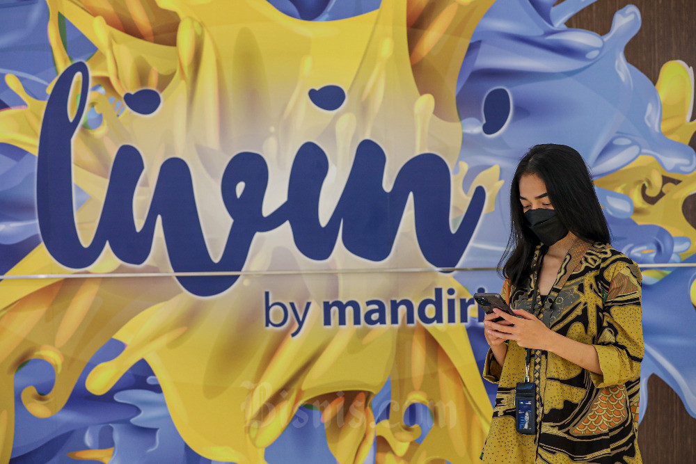 Nasabah menunjukan aplikasi Livin’ by Mandiri di salah satu kantor cabang Bank Mandiri, Jakarta. Bisnis/Abdurachman