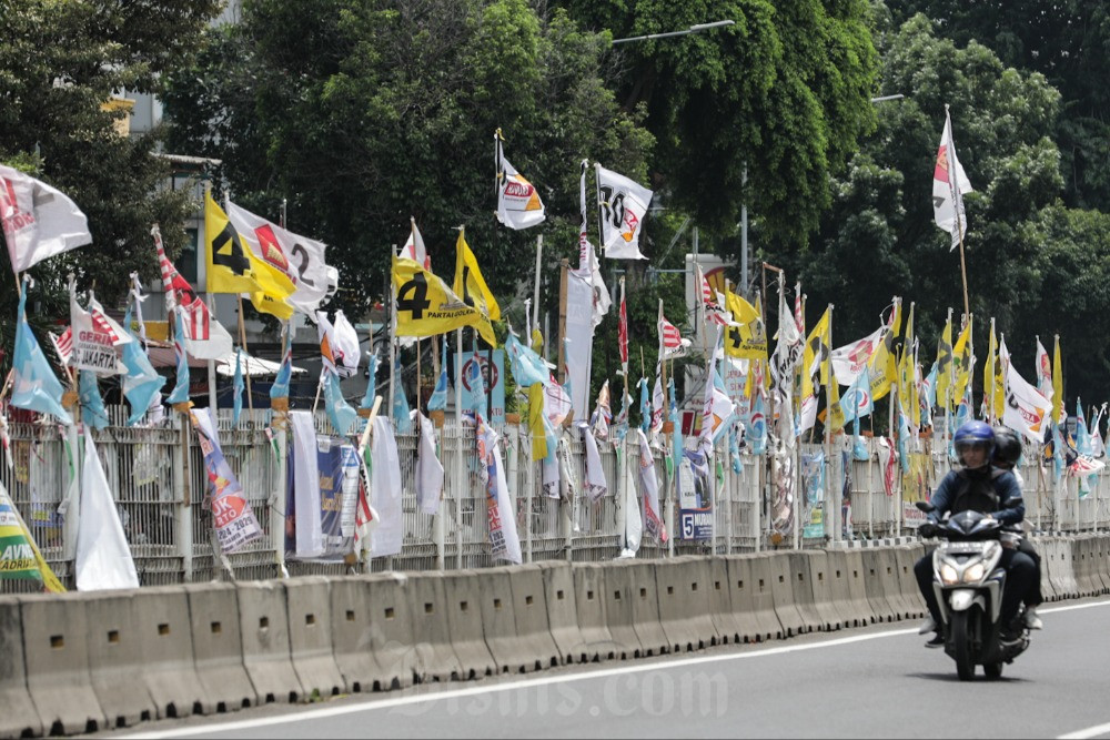 Ilustrasi pengendara melintasi baliho calon anggota legislatif dan partai politik./JIBI