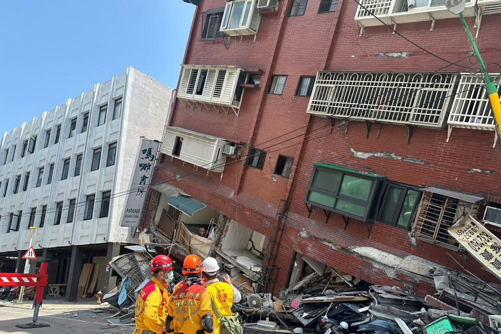 Petugas pemadam kebakaran bekerja di lokasi di mana sebuah bangunan runtuh akibat gempa bumi, di Hualien, Taiwan, 3 April 2024/Reuters/Taiwan National Fire Agency