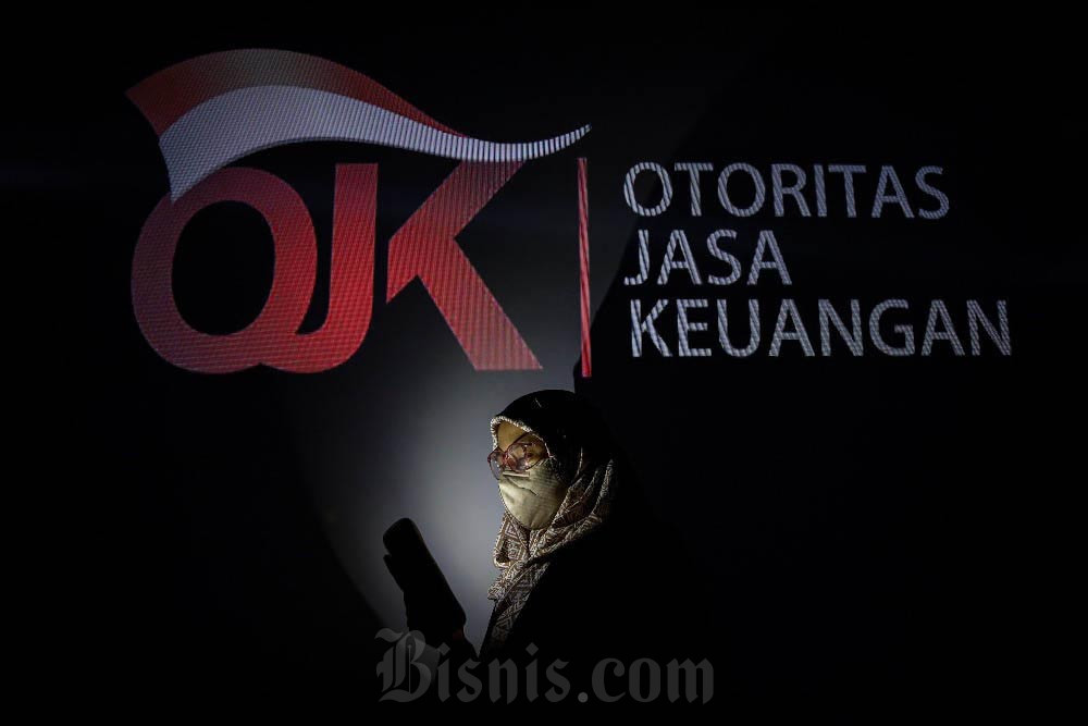 Foto multiple exposure warga beraktivitas di dekat logo Otoritas Jasa Keuangan (OJK) di Jakarta, Minggu (31/12/2023). Arief Hermawan P