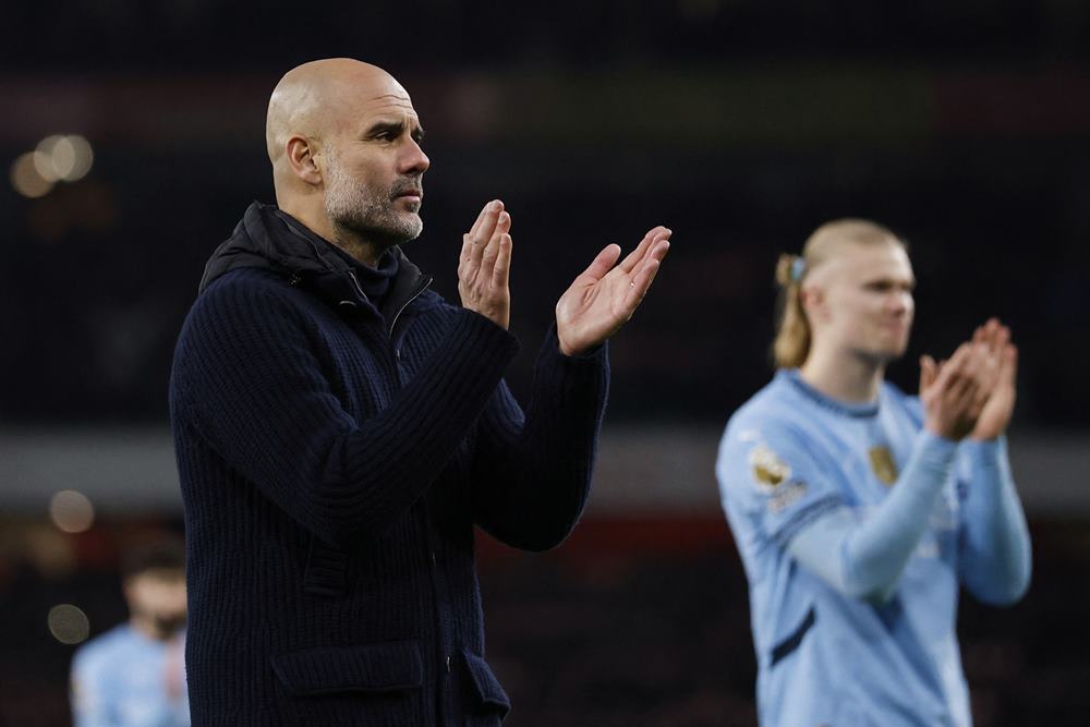 Manajer Manchester City, Pep Guardiola bersama Erling Haaland /Reuters-Peter Cziborra