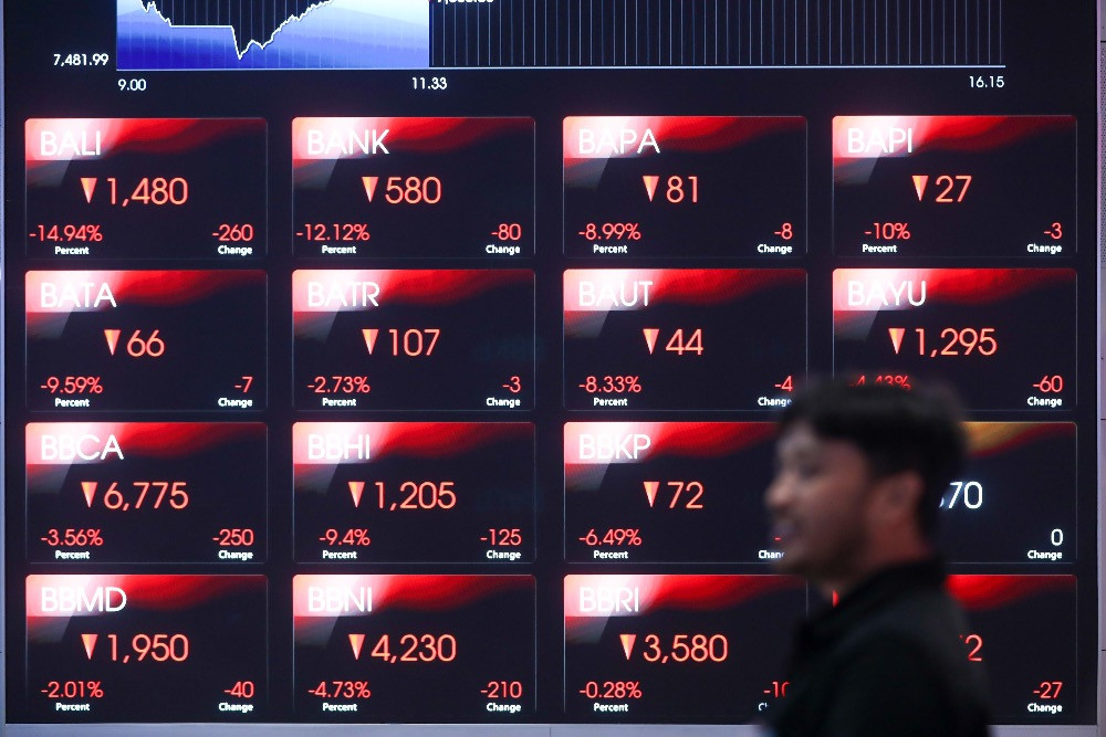 Pegawai mengamati pergerakan harga saham di galeri BEI, Jakarta, Kamis (29/1/2026)./Bisnis/Himawan L. Nugraha