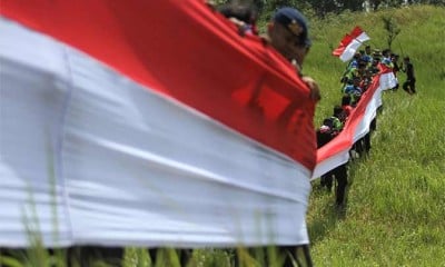 MEMBENTANGKAN BENDERA MERAH PUTIH DI PUNCAK GUNUNG