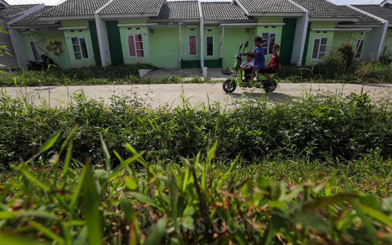 Warga melintas di salah satu perumahan subsidi di Ciampea, Bogor, Jawa Barat, Senin (6/1/2023). Badan Pengelola Tabungan Perumahan Rakyat (BP Tapera) menargetkan akan menyalurkan dana FLPP tahun 2023 sebanyak 220.000 unit rumah atau senilai Rp25,18 triliun sedangkan untuk Pembiayaan Tapera sebanyak 10.000 unit senilai Rp1,05 triliun. Bisnis/Himawan L Nugraha