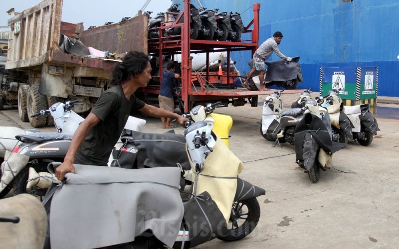 Pekerja memindahkan sepeda motor yang baru diturunkan dari kapal untuk dikirim ke dealer di Pelabuhan Makassar, Sulawesi Selatan, Selasa (28/3/2023). Berdasarkan data Asosiasi Industri Sepeda Motor Indonesia (AISI) penjualan kendaraan bermotor roda dua pada Januari 2023 tercatat mencapai 608.244 unit atau tumbuh 37 persen secara tahunan (year-on-year/yoy). Bisnis/Paulus Tandi Bone