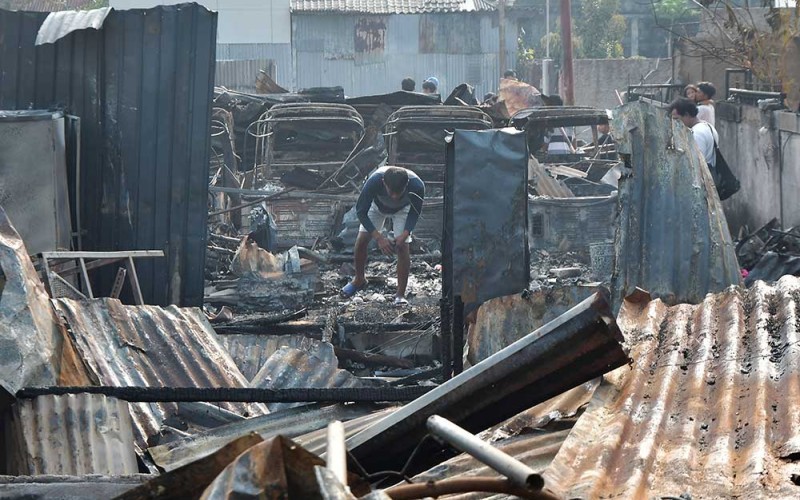 Seorang warga mencari sisa barang usai kebakaran rumah semipermanen di Duren Sawit, Jakarta Timur, Selasa (30/5/2023). Menurut petugas sebanyak 19 unit mobil pemadam dikerahkan untuk memadamkan api dalam kebakaran yang terjadi pada Selasa (30/5) pukul 02.40 WIB dan mengakibatkan satu orang meninggal dunia, sementara penyebab kebakaran masih dalam penyelidikan pihak terkait. ANTARA FOTO/Fakhri Hermansyah