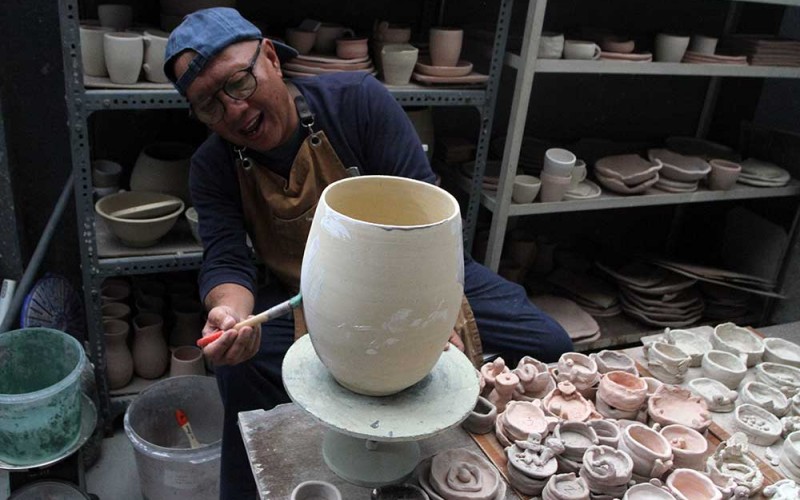 Seniman kriya Muchis Arif membuat mangkok keramik bergaya kontemporer di Studio Keramik Matahati, Temas, Batu, Jawa Timur, Rabu (7/6/2023). Kerajinan keramik tersebut dijual kepada konsumennya yakni para chef, pengusaha restoran, pengusaha kafe, dan kolektor keramik di berbagai kota di Indonesia dengan harga Rp50 ribu hingga Rp15 juta rupiah per buah tergantung keunikan dan keindahan warnanya. ANTARA FOTO/Ari Bowo Sucipto