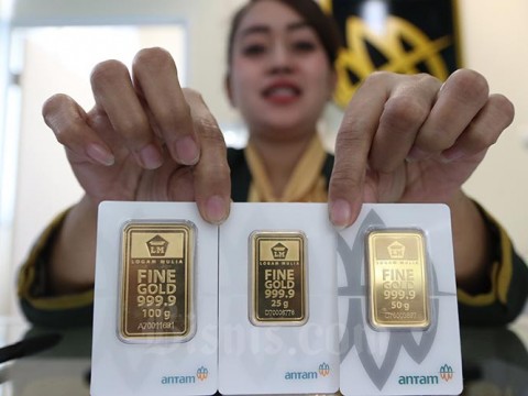 Karyawan menunjukan emas batangan di Butik Emas Logam Mulia, Jakarta, Kamis (13/2/2020). Bisnis/Eusebio Chrysnamurti