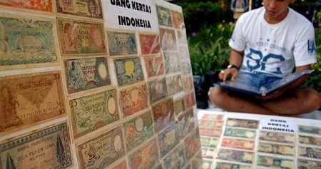 Pedagang menggelar koin dan uang kertas kuno berbagai pecahan, di Monumen Arek Lancor, Pamekasan, Madura, Jatim, Minggu (17/5/2015)./Antara-Saiful Bahri