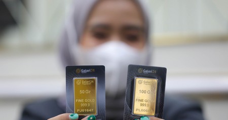 Karyawan menunjukkan emas 24 karat di Galeri 24 Pegadaian di Jakarta. Bisnis/Himawan L Nugraha