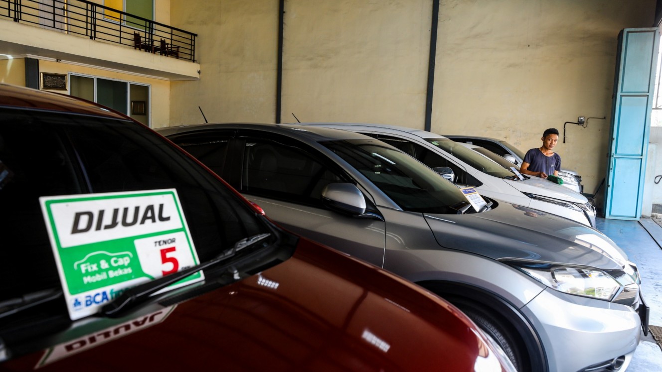 Karyawan membersihkan mobil disalah satu showroom mobil bekas di Kabupaten Bogor, Jawa Barat, Selasa (16/7/2024)/JIBI/Bisnis/Abdurachman