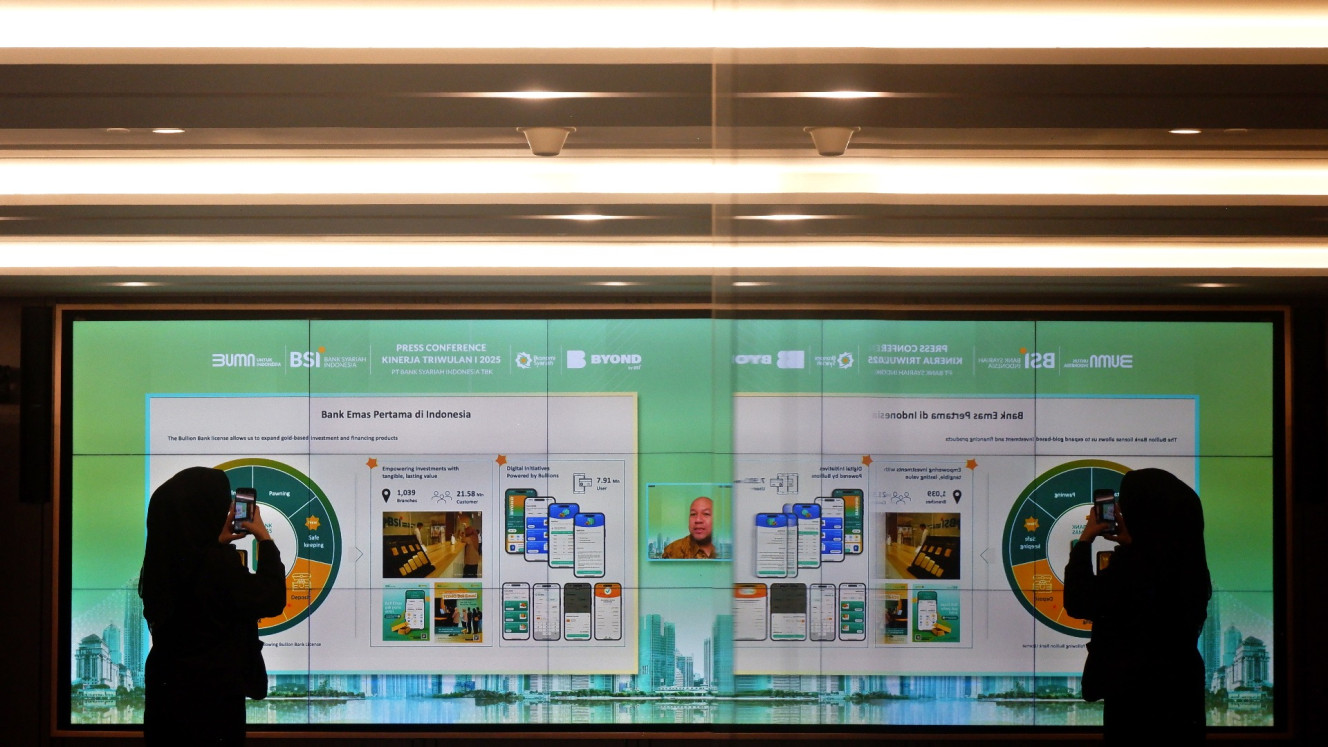 Karyawan berada di depan layar presentasi saat rilis kinerja triwulan I-2025 Bank Syariah Indonesia (BSI) di Jakarta, Rabu (30/4/2025). /Bisnis.com/Nurul Hidayat