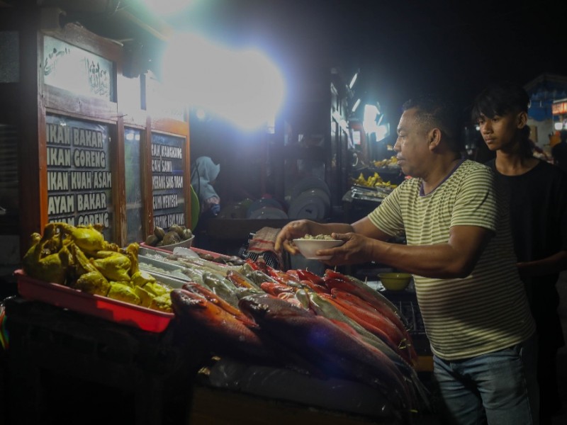 Pedagang menyiapkan ikan segar untuk masakan olahan seafood khas Kupang di Pasar Malam Kampung Solor, Kota Lama, Kupang, NTT, Jumat (24/11/2023). 