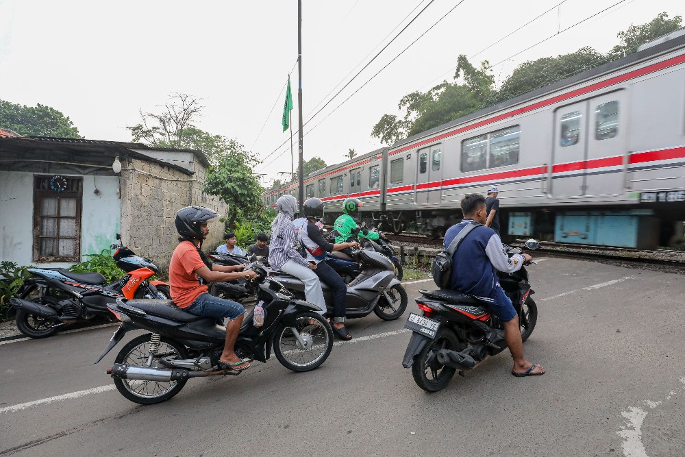 Sejumlah kendaraan melintasi perlintasan kereta api tanpa palang di kawasan Pondok Ranji, Tangerang Selatan, Banten, Senin (6/4/2026)./Bisnis-Eusebio Chrysnamurti